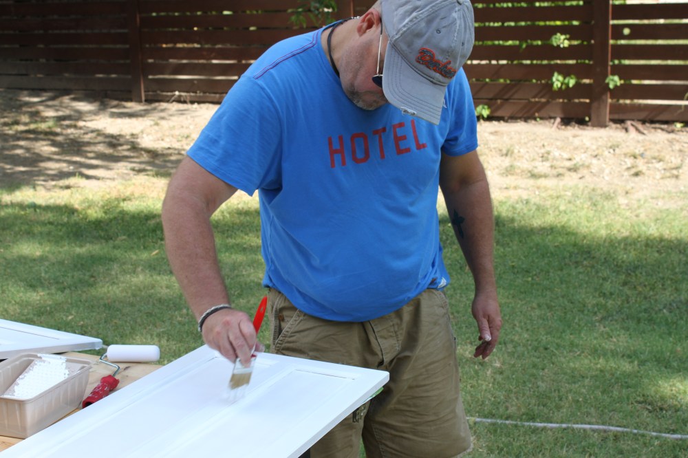 Jamie painting the cabinet doors