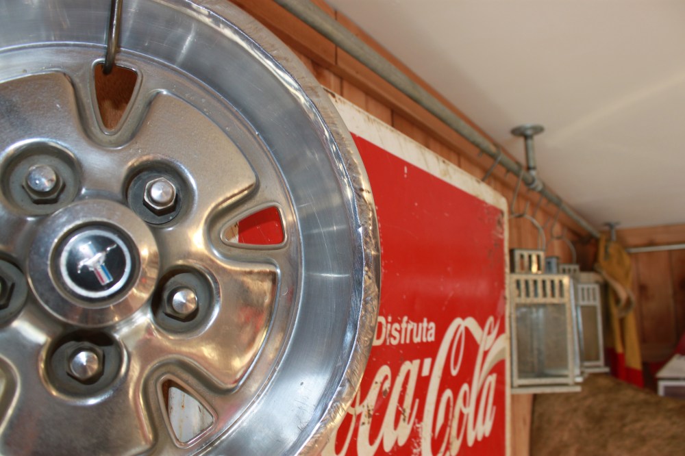 Mustang Hubcap on Ceiling Pipe