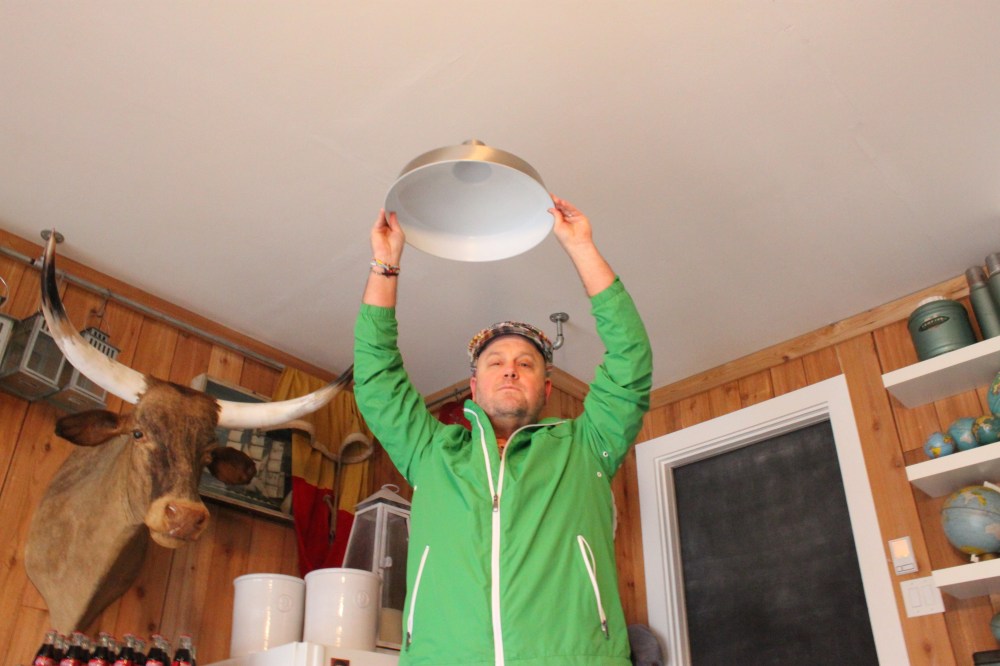 Jamie Holding Barn Pendant Light in Place
