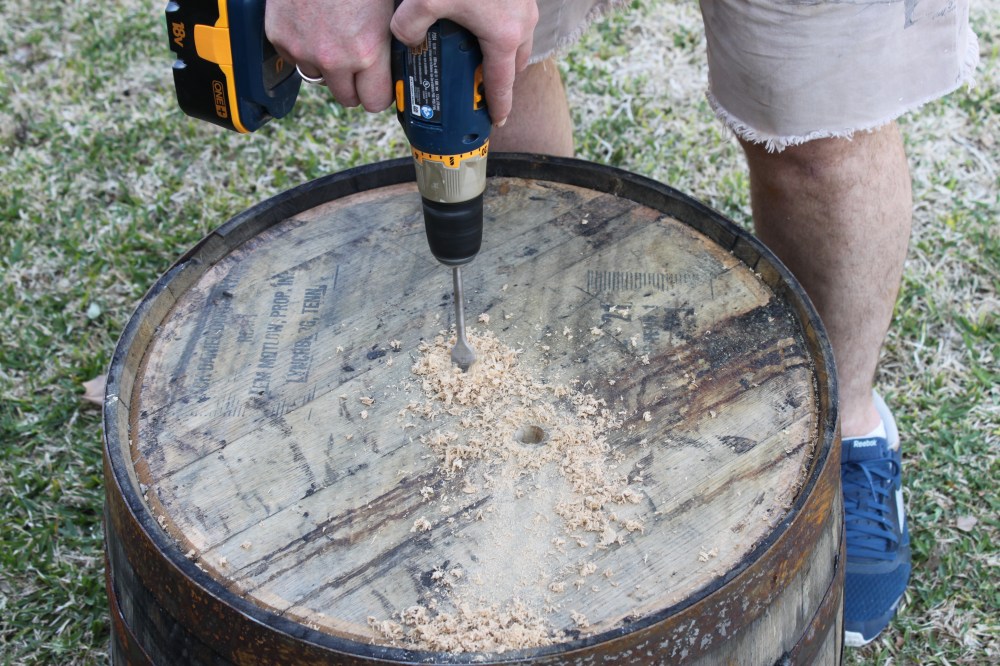 Jamie Drilling Drainage Holes in the Bottom of a Whiskey Barrel
