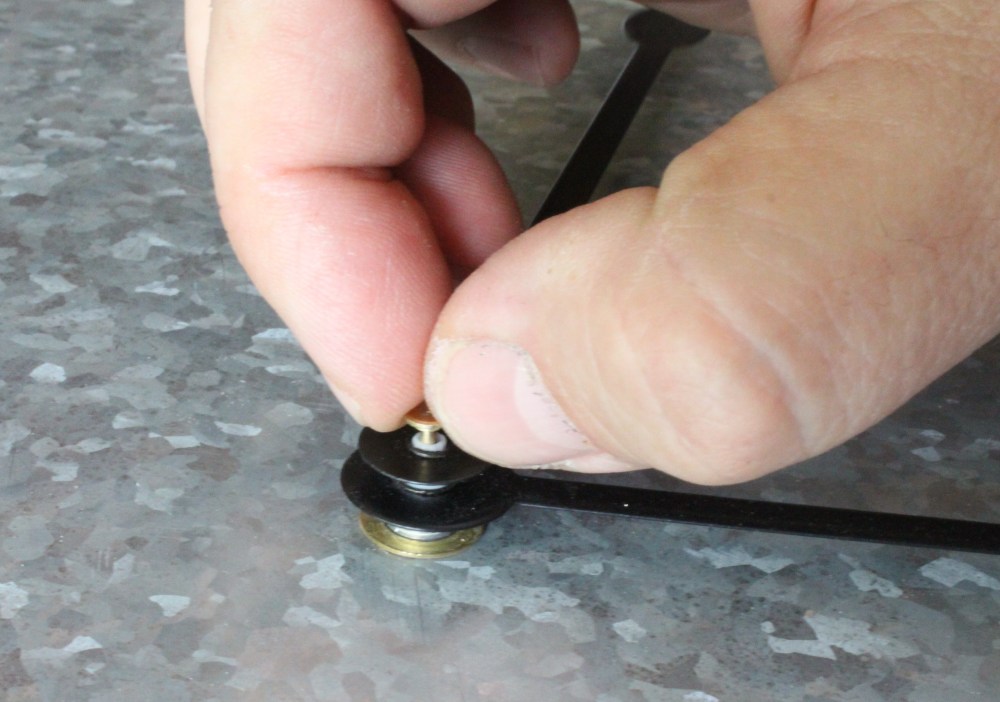 Pull the Small pin Carefully from the Center of Hands