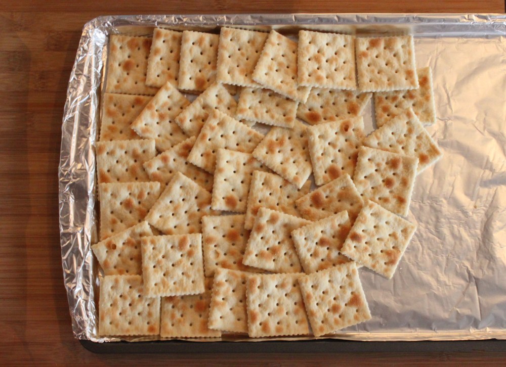 Layer the Saltines on a foil covered cookie sheet