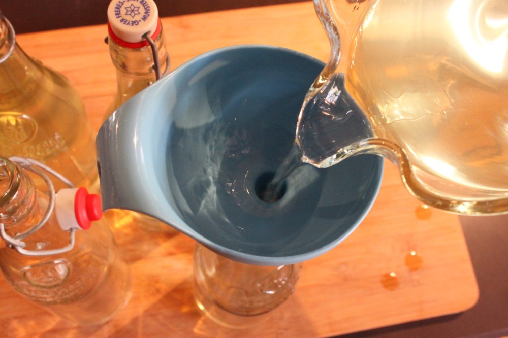 Use a Funnel to Fill Your Clean Bottles with Infused Vodka
