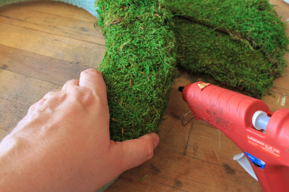 Carefully Use a Hot Glue Gun to Attach the Moss to the Wreath Form
