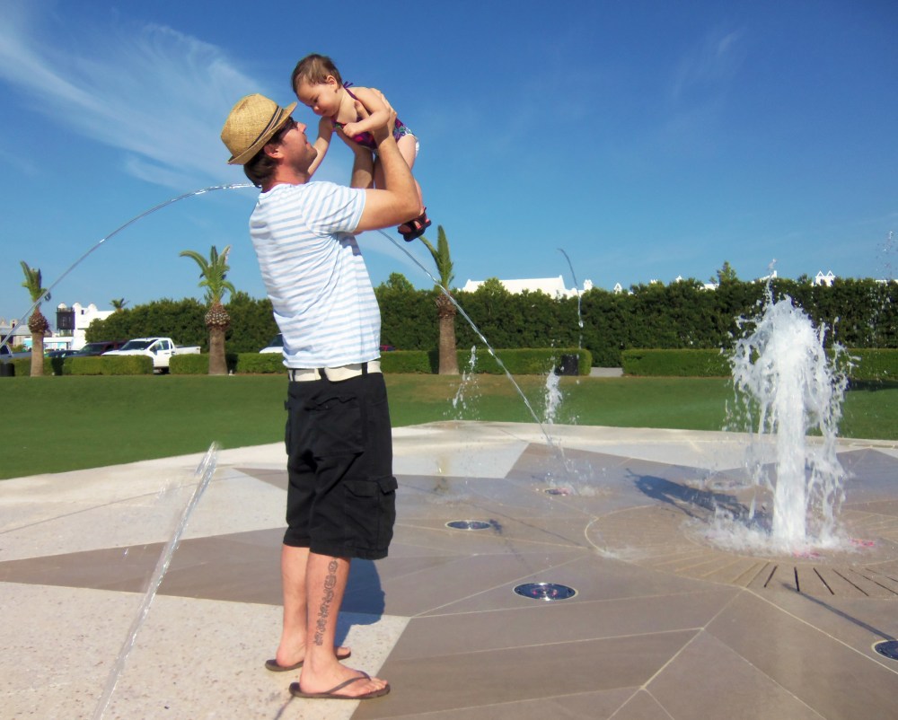 Gert and Baby Madeleine Playing in the Alys Beach Fountain