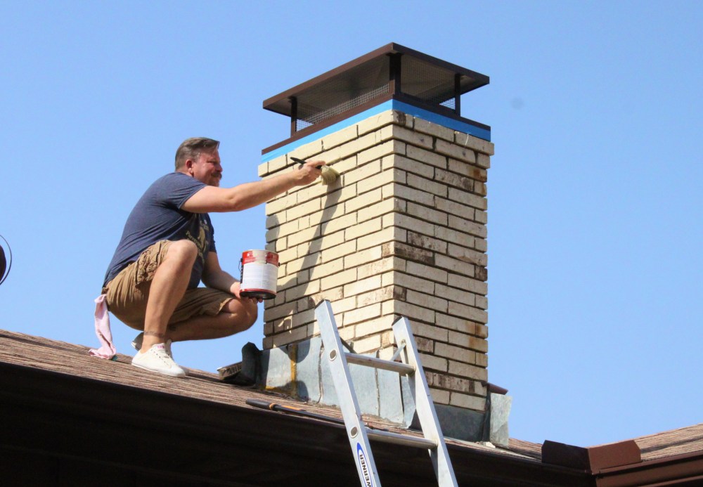 James Painting the Chimney to Match the Rest of the House
