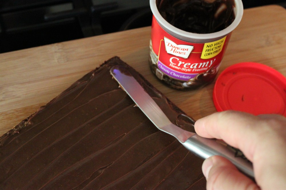 Spread a Thin Layer of Frosting Across the Chilled Brownies so the Ghosts Will Stick
