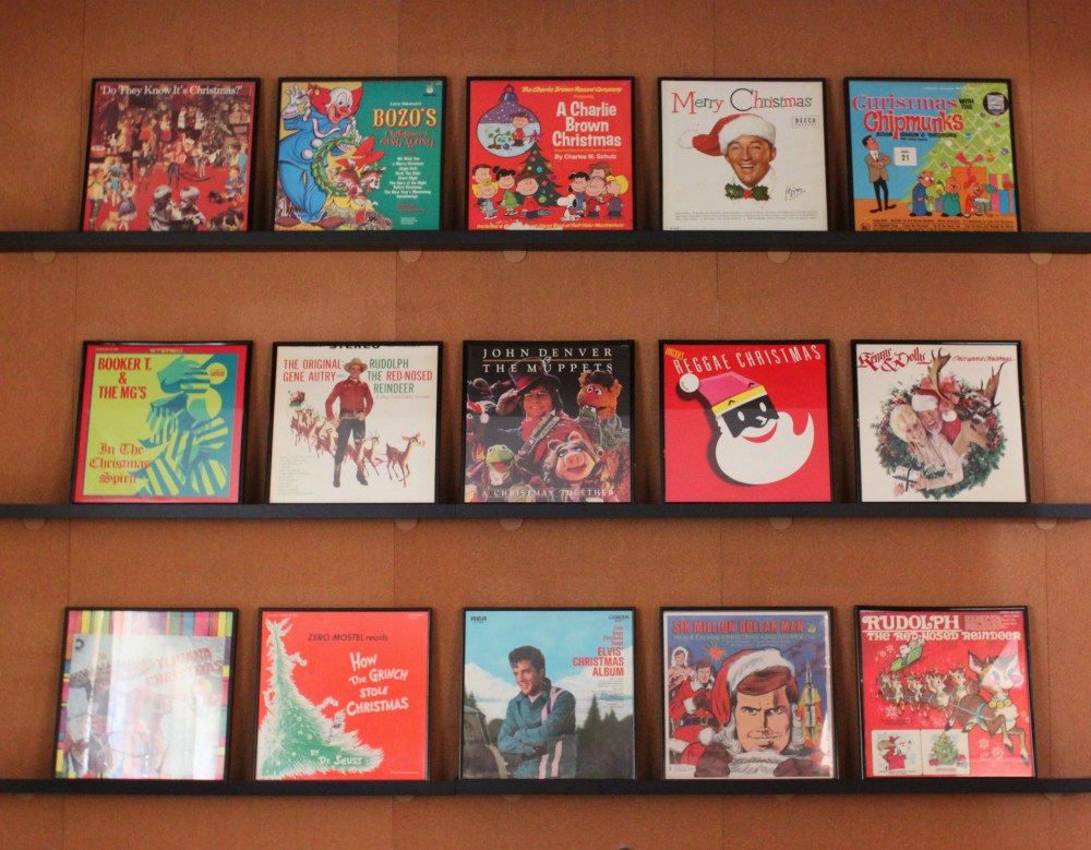 Wall of Framed Holiday Records in the Cavender Diary Living Room
