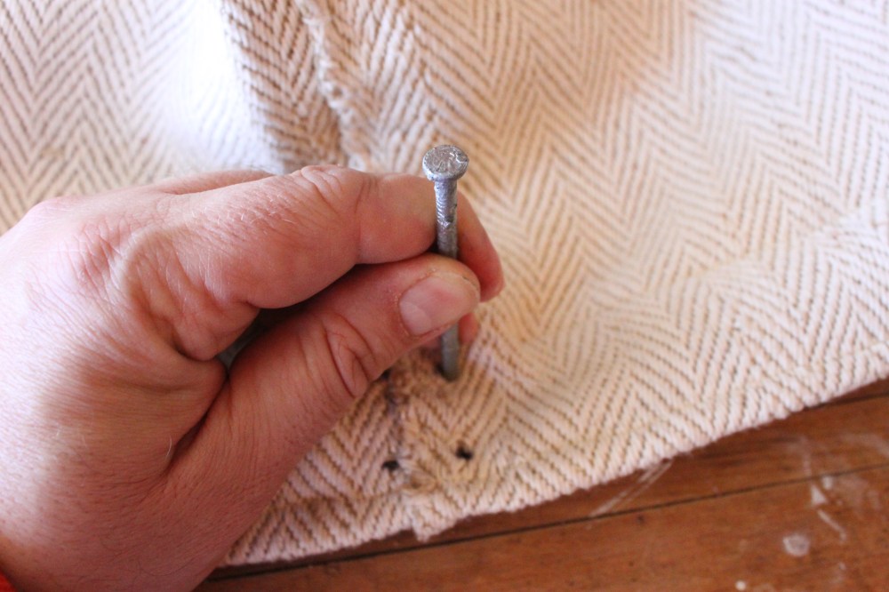 Use the nail to Poke Through the Grain Sack Edge