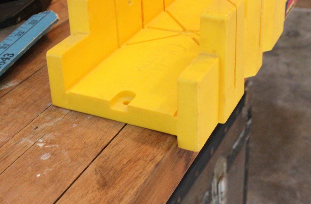 The Miter Box has a Lip thet Hugs the Edge of the Worktable