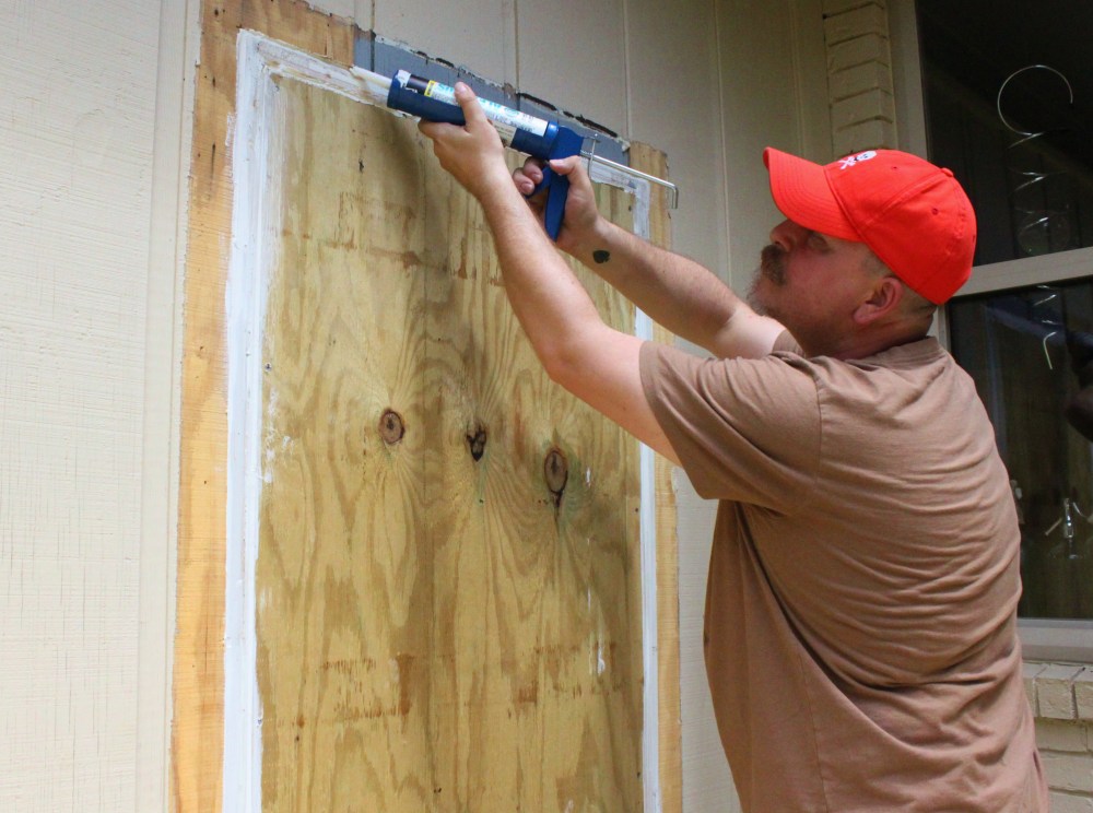JAmes Adding Caulk Around the Unused Garage Door