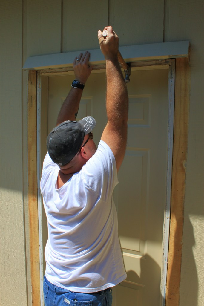 Jamie Prying the Trim Off the Unused Garage Door