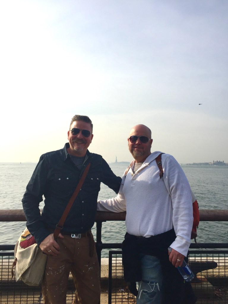 James and Jamie with the tiny Little Statue of Liberty in the BAckground