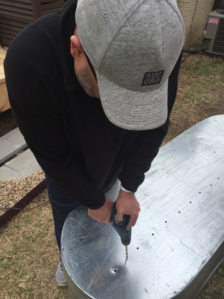 Jamie Drilling Drainage Holes in the Botom of the Horse Trough