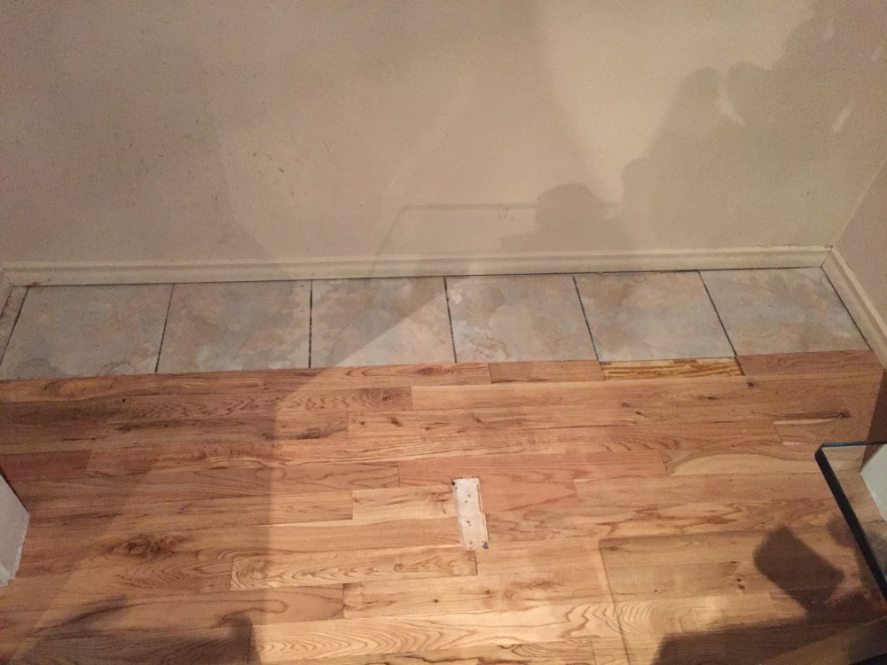 Half a Wood Floor and Half Vinyl Stick-Em Tile